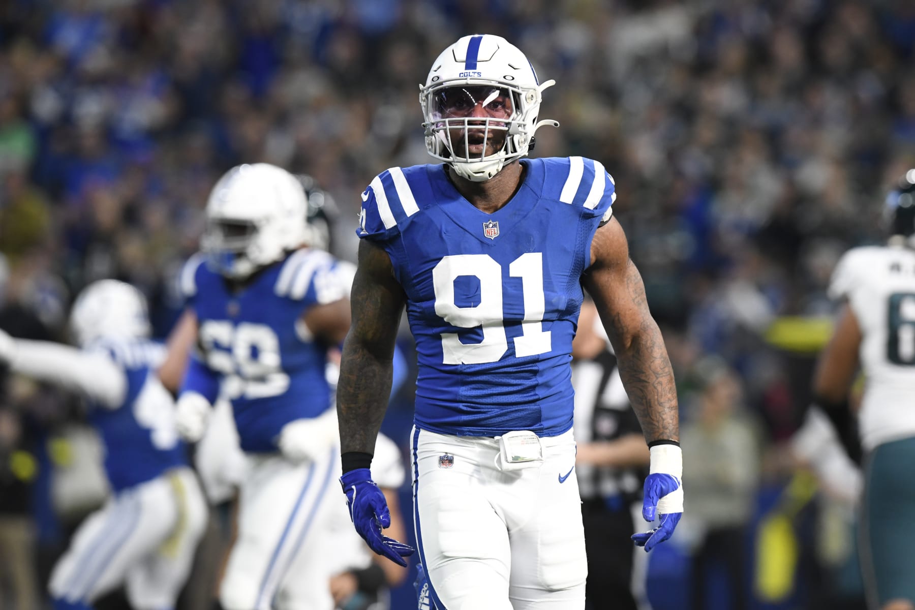 INDIANAPOLIS, IN - NOVEMBER 20: Indianapolis Colts Defensive End Yannick Ngakoue (91) reacts after tackling Philadelphia Eagles Quarterback Jalen Hurts (1) during the NFL football game between the Philadelphia Eagles and the Indianapolis Colts on November 20, 2022, at Lucas Oil Stadium in Indianapolis, Indiana. (Photo by Michael Allio/Icon Sportswire via Getty Images)